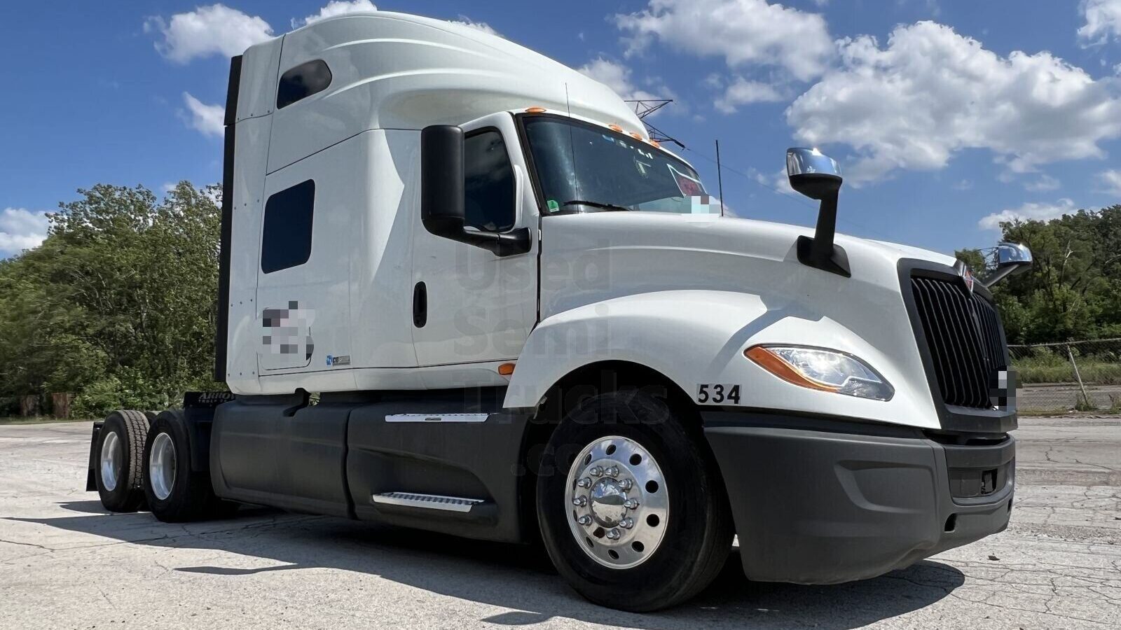 A white International LT625 sleeper truck