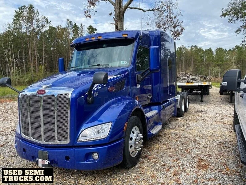 A blue Peterbilt 579 semi truck with automatic transmission