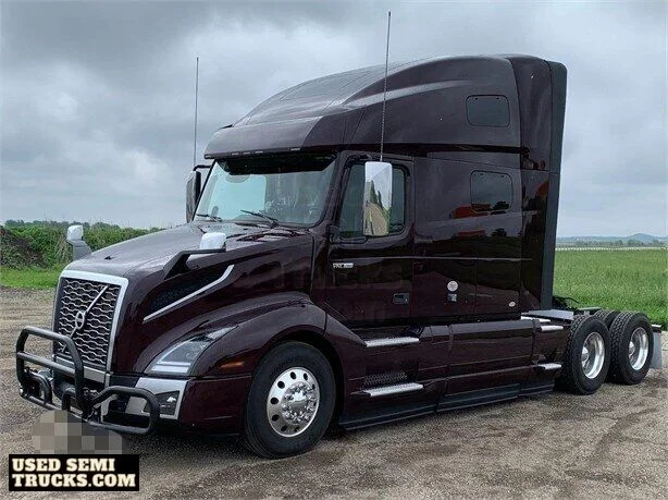 A medium aubergine pearl Volvo VNL semi truck with automatic transmission